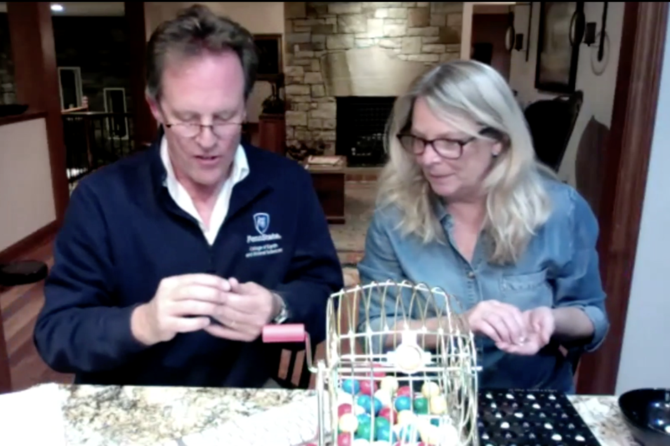 Lee Kump, the John Leone Dean in the College of Earth and Mineral Sciences reads off a bingo number with his wife Michelle.