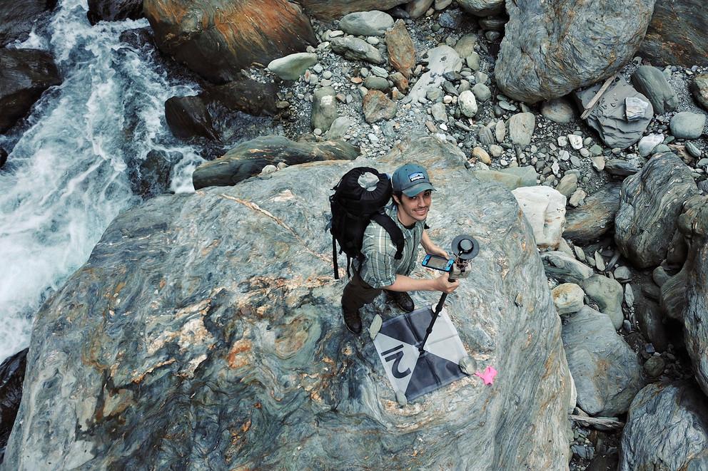 Roman DiBiase uses a portable GPS receiver and smartphone to survey ground control points for a drone survey