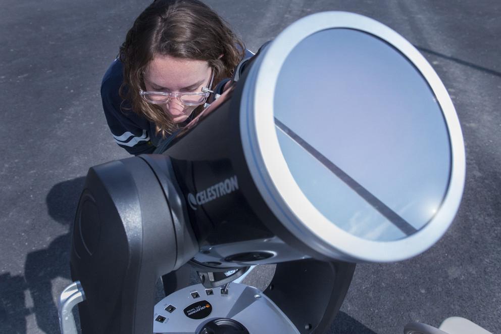 Chloe Stanton, a NASA PA Space Grant Fellow, has a look at the sun through a highly-filtered telescope 